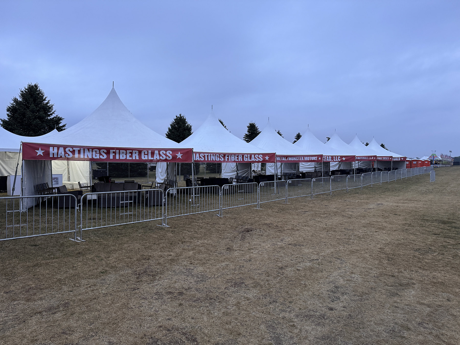 Sponsor banners running along a row of VIP tents
