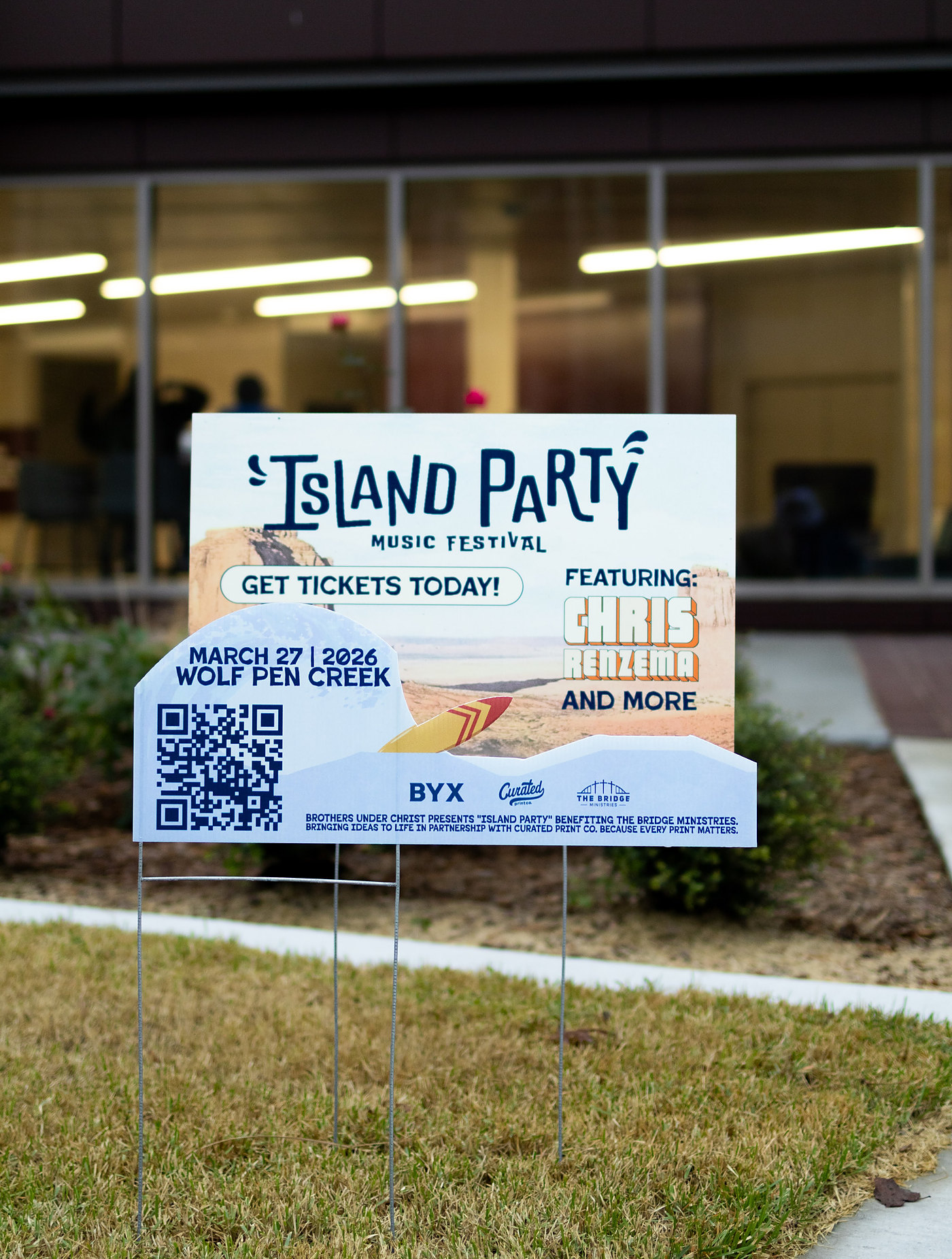 Island Party yard sign installed on a campus lawn